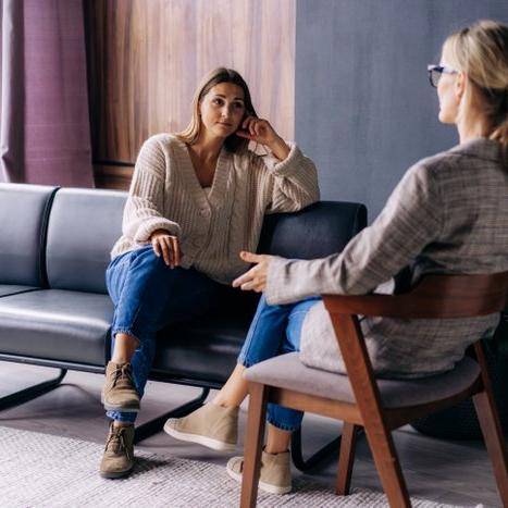 Lady sitting on couch talking with therapist