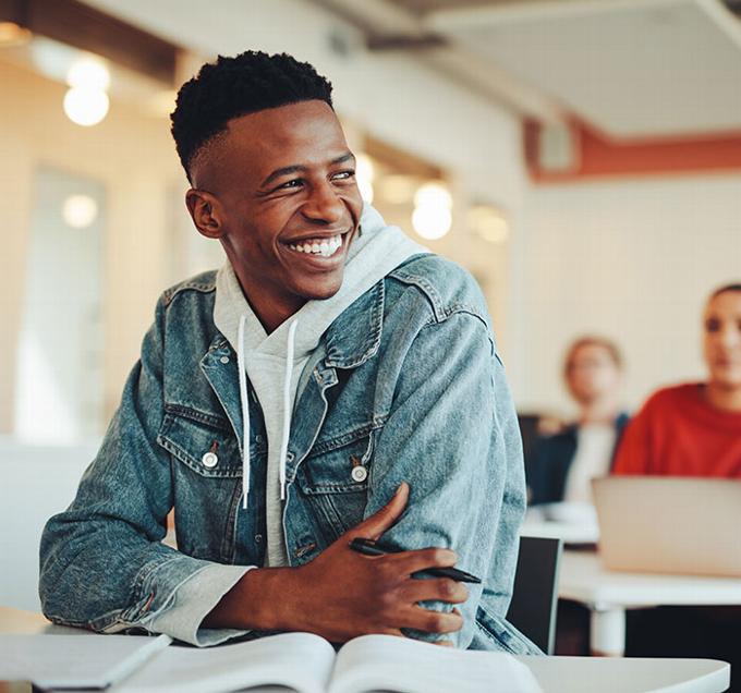 Male student smiling in class