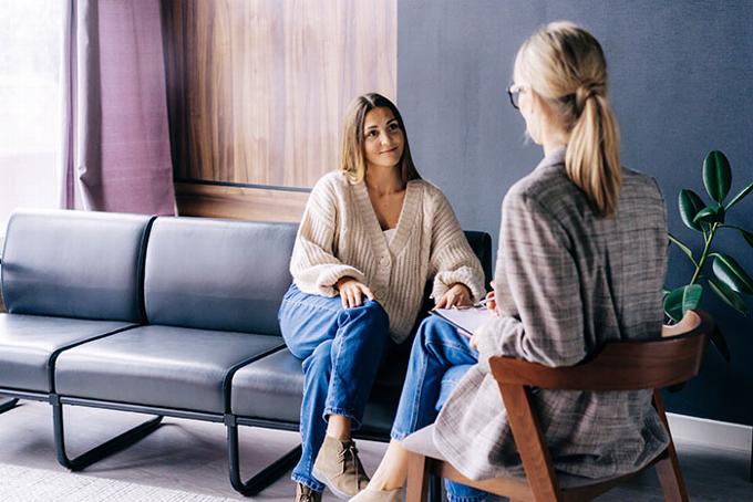 lady sitting on sofa talking with therapist